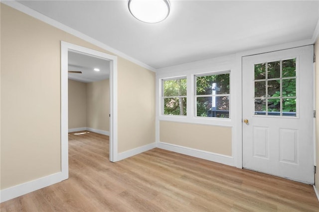 unfurnished room featuring crown molding, ceiling fan, and light wood-type flooring