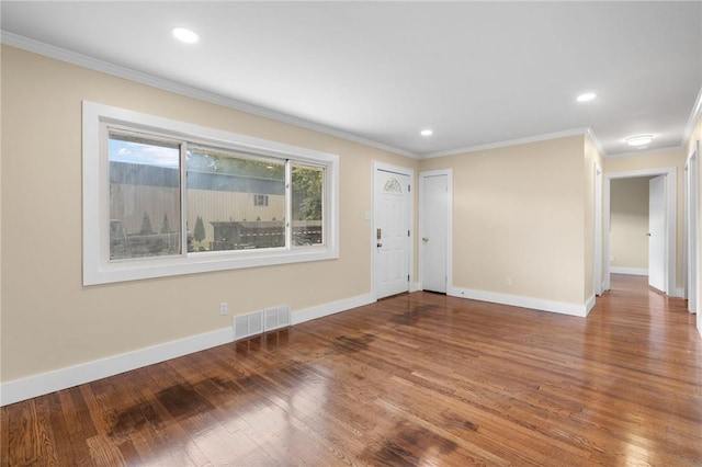 spare room featuring wood-type flooring and ornamental molding