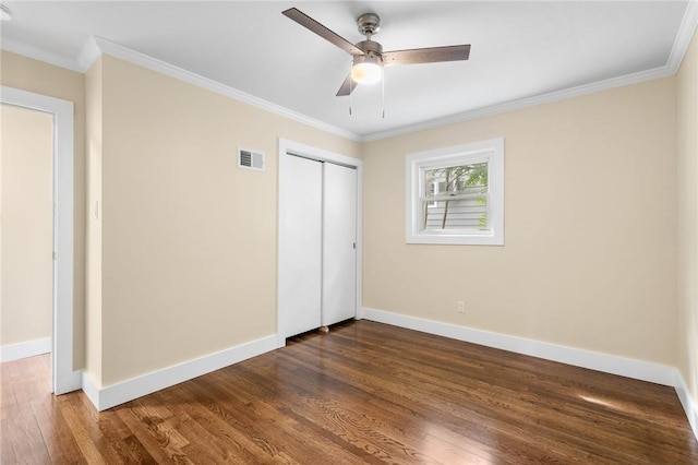 unfurnished bedroom with ceiling fan, dark hardwood / wood-style floors, and ornamental molding