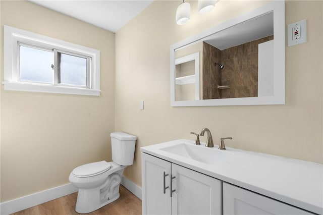 bathroom featuring vanity, wood-type flooring, and toilet