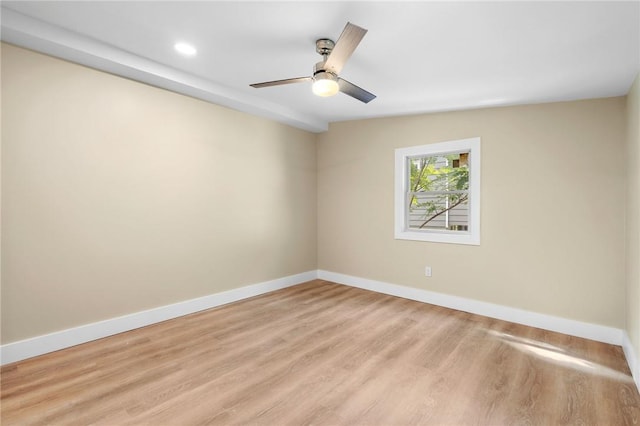 empty room featuring ceiling fan, lofted ceiling, and light wood-type flooring