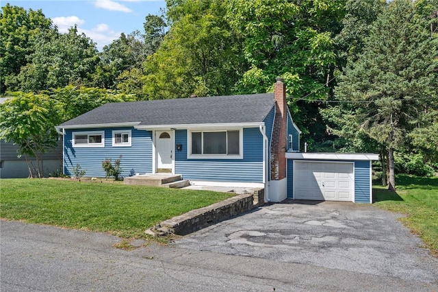 ranch-style house with an outbuilding, a garage, and a front lawn