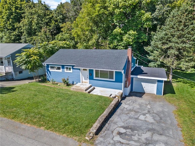 view of front of property featuring a garage and a front lawn