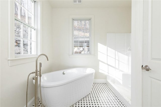 bathroom with a tub to relax in