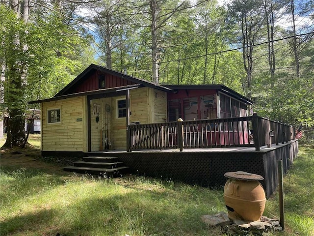 rear view of property featuring a deck