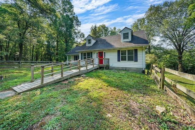 cape cod home with a front yard and a wooden deck