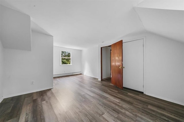 bonus room featuring dark hardwood / wood-style flooring, a baseboard radiator, and vaulted ceiling