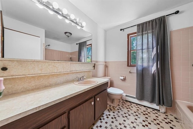 full bathroom with baseboard heating, shower / bath combination, toilet, vanity, and tile walls