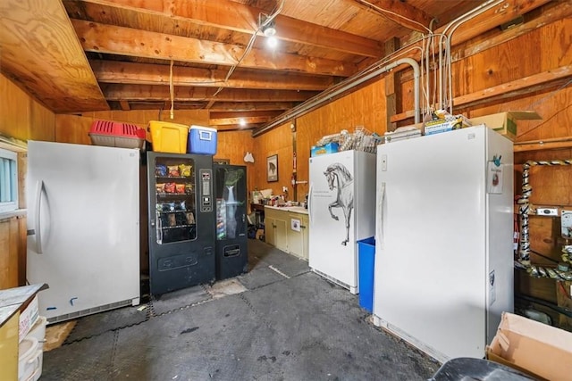 kitchen featuring white fridge and wooden walls