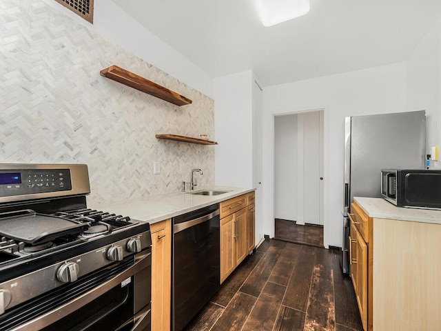 kitchen featuring appliances with stainless steel finishes, dark hardwood / wood-style floors, and sink