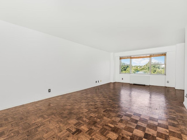 unfurnished room with dark parquet floors