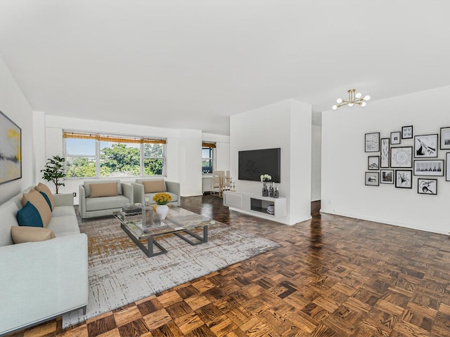 living room featuring dark parquet floors and an inviting chandelier