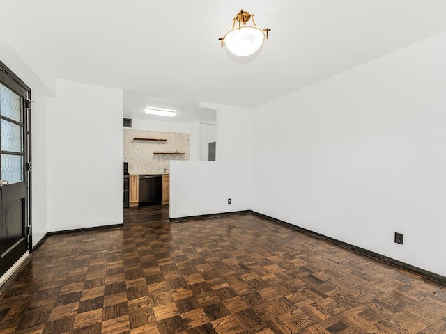 unfurnished living room with dark parquet flooring