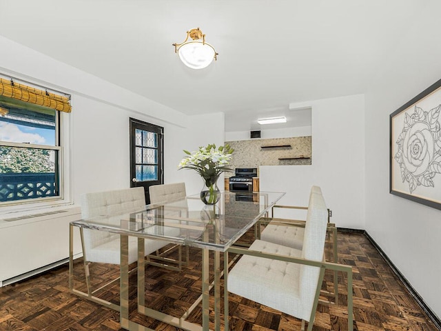 dining area with dark parquet floors