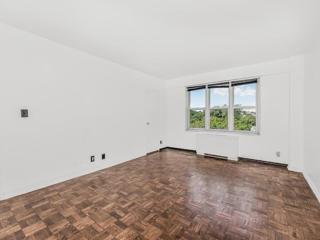 empty room with dark parquet flooring