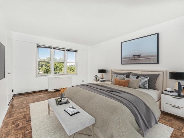 bedroom featuring dark parquet flooring and radiator