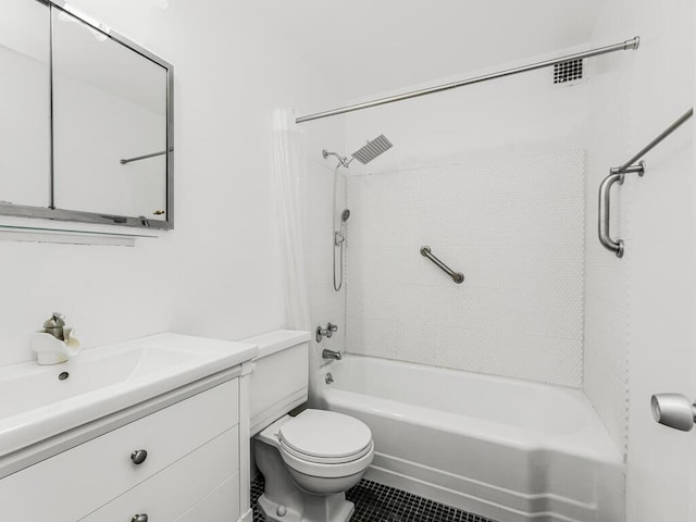 full bathroom featuring tile patterned floors, vanity, toilet, and tiled shower / bath