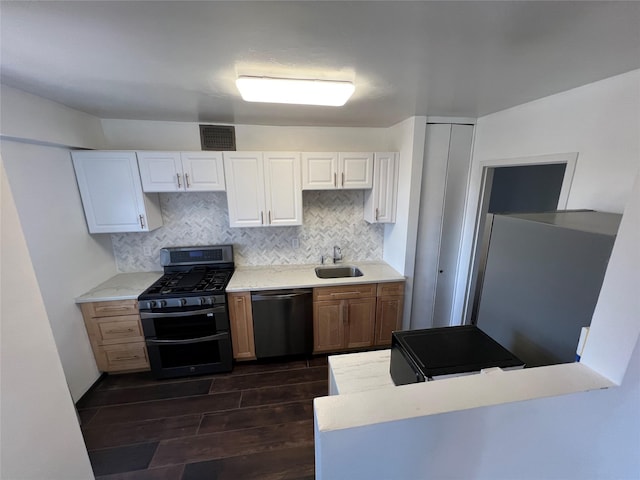 1200 Midland Ave Unit 10F, Bronxville, NY 10708 - kitchen featuring tasteful backsplash, a sink, dark wood-style floors, visible vents, and appliances with stainless steel finishes