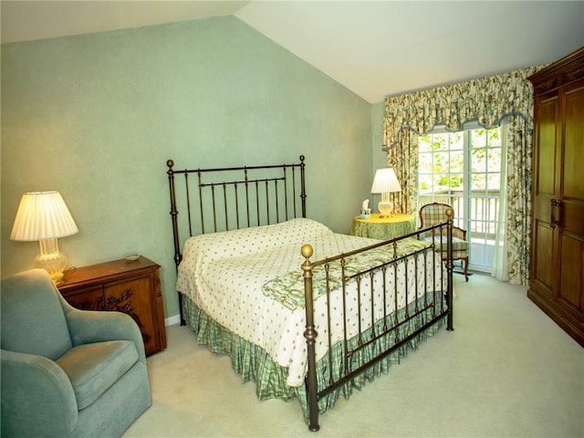 carpeted bedroom with lofted ceiling