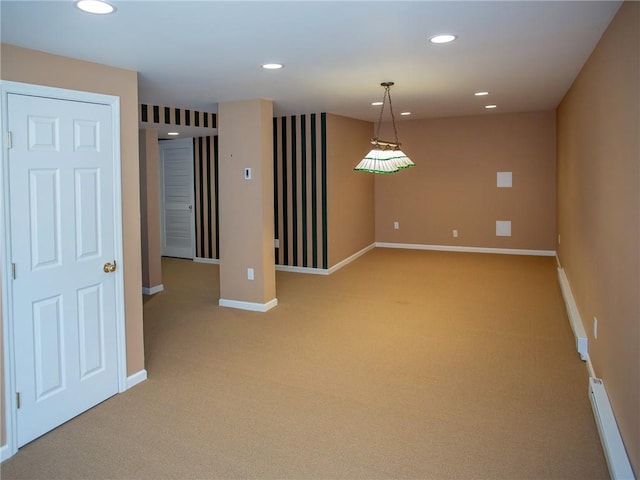 carpeted spare room with baseboard heating