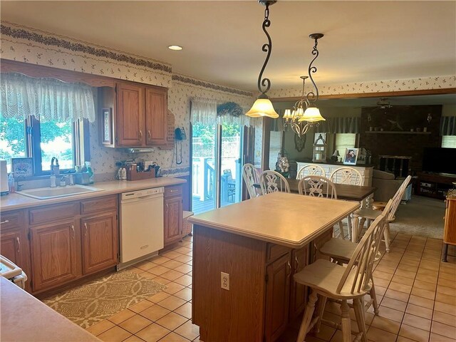 98 Pelham Dr, Cornwall, NY 12518 - kitchen with white dishwasher, light tile patterned floors, a sink, light countertops, and wallpapered walls