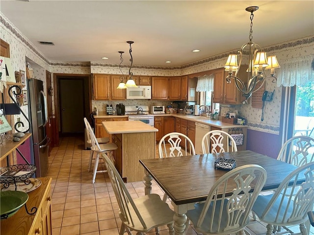 98 Pelham Dr, Cornwall, NY 12518 - dining area featuring wallpapered walls, a chandelier, light tile patterned floors, and a toaster