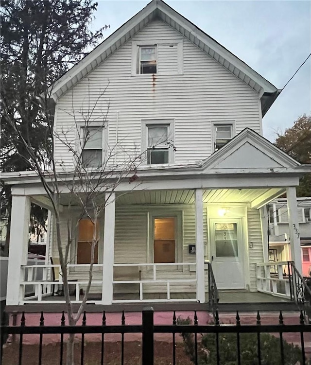 rear view of house featuring a porch