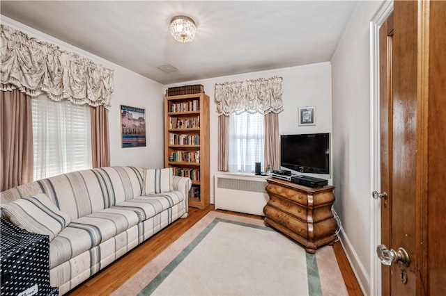 living room featuring radiator and light wood-type flooring