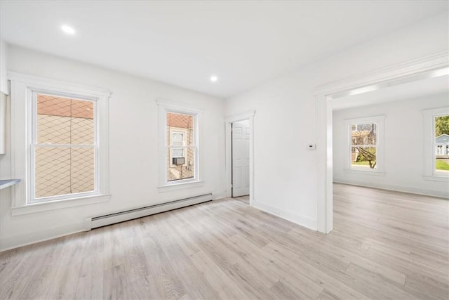 spare room with light hardwood / wood-style flooring and a baseboard heating unit