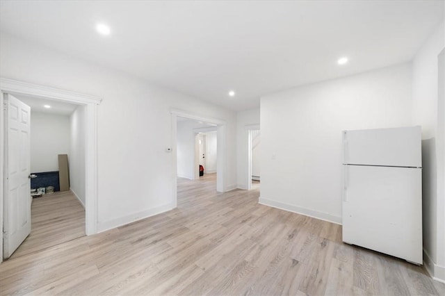 interior space with light wood-type flooring and a baseboard radiator