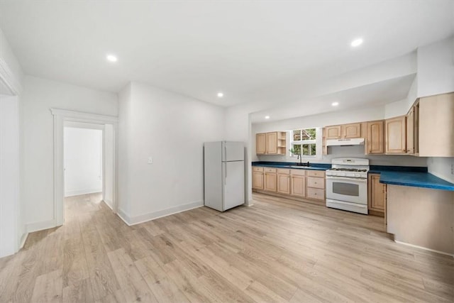 kitchen featuring light brown cabinetry, white appliances, and light hardwood / wood-style flooring