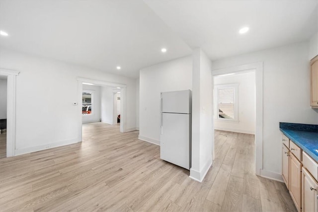 kitchen featuring light wood-type flooring, light brown cabinetry, and white refrigerator