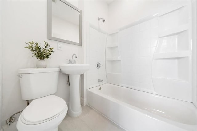 bathroom featuring toilet, tile patterned floors, and bathing tub / shower combination