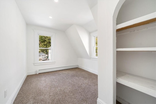 additional living space featuring carpet, lofted ceiling, and baseboard heating