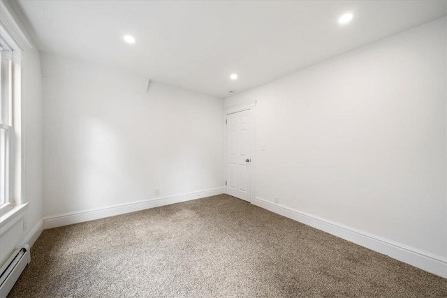 empty room with baseboard heating and carpet floors