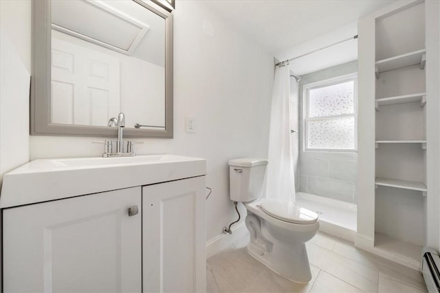 bathroom with curtained shower, baseboard heating, tile patterned flooring, toilet, and vanity