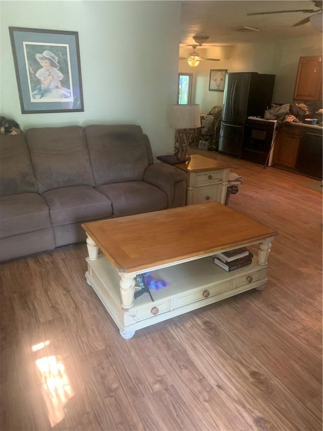 living room with ceiling fan and light hardwood / wood-style floors