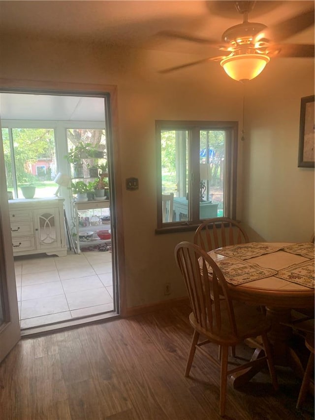 dining room with wood-type flooring, ceiling fan, and a healthy amount of sunlight