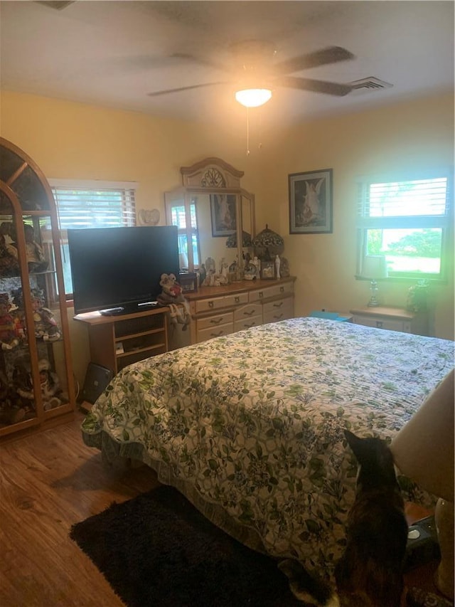 bedroom with hardwood / wood-style floors and ceiling fan