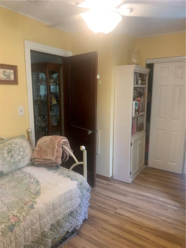 bedroom with hardwood / wood-style floors and ceiling fan