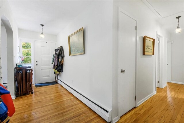 entryway featuring a baseboard radiator and wood-type flooring