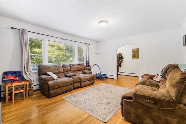 living room with baseboard heating and light wood-type flooring