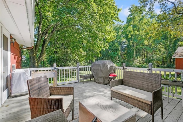 wooden terrace with outdoor lounge area and area for grilling