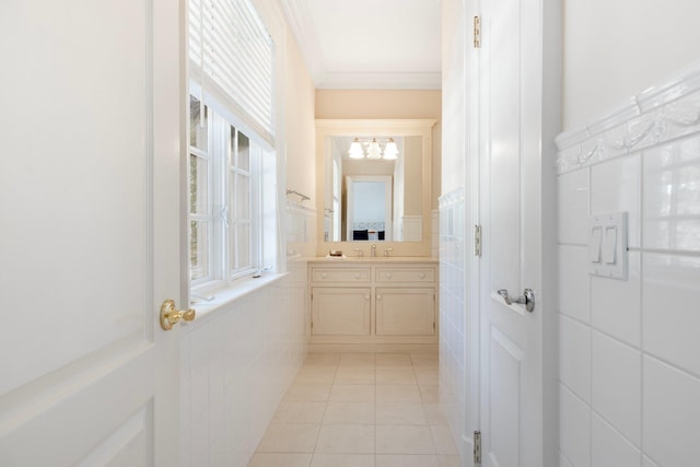 bathroom featuring vanity, ornamental molding, tile patterned flooring, and tile walls