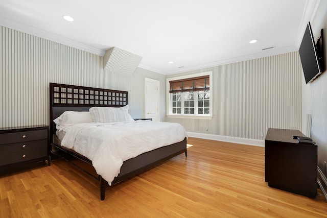 bedroom featuring wallpapered walls, light wood-style flooring, ornamental molding, and baseboards