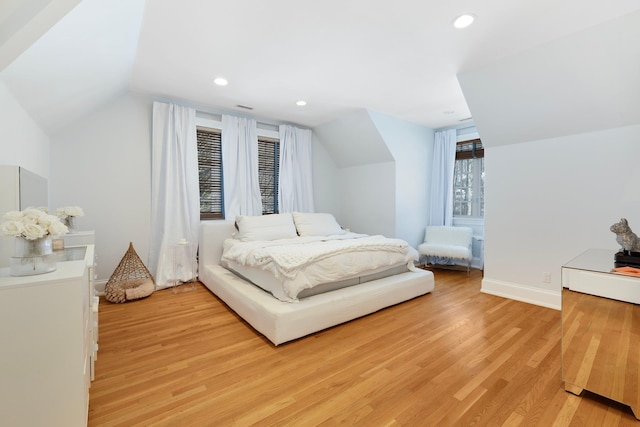 bedroom with vaulted ceiling, light wood finished floors, baseboards, and recessed lighting