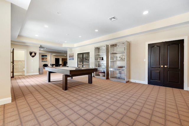 rec room with a tray ceiling, visible vents, billiards, and light carpet