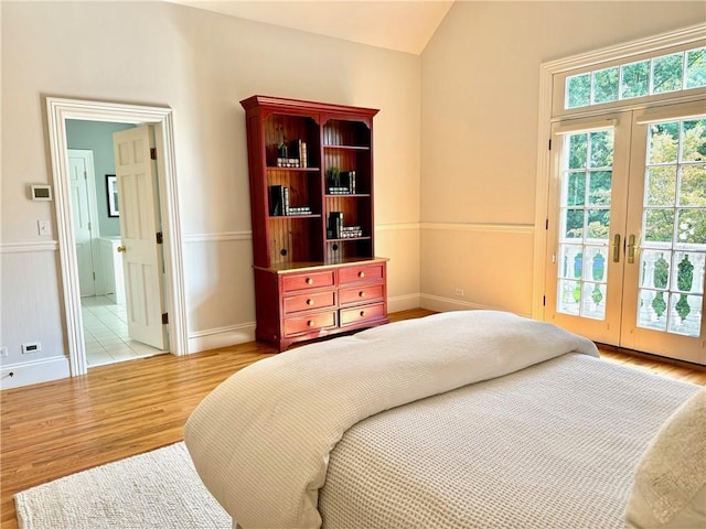 778 Sleepy Hollow Rd, Briarcliff Manor, NY 10510 - bedroom featuring access to outside, wood finished floors, french doors, vaulted ceiling, and connected bathroom