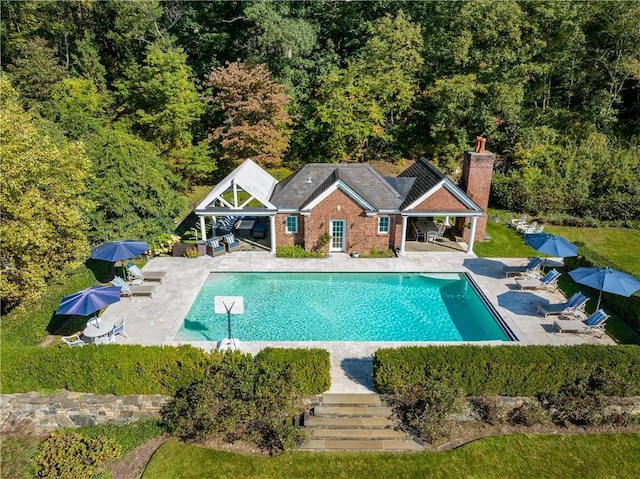 778 Sleepy Hollow Rd, Briarcliff Manor, NY 10510 - swimming pool with a patio, a storage structure, an outbuilding, and a view of trees