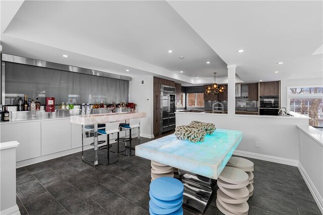 dining area featuring sink and an inviting chandelier